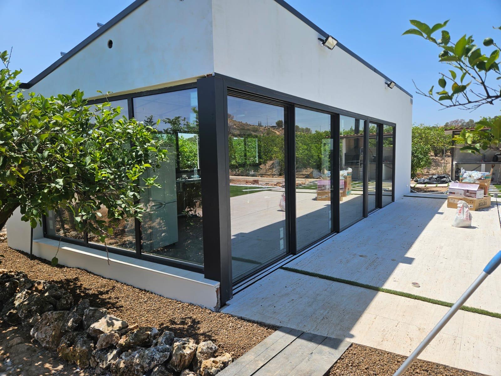 Lateral del cerramiento de aluminio y cristal junto al jardín